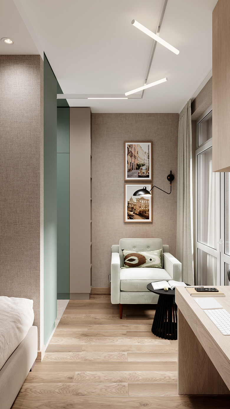 фото:Компактная комната в современном стиле с зонированием: спальная зона с лаконичной кроватью, рабочая — с минималистичным столом и техникой, лаунж-зона — с мягким светло-зелёным креслом и круглым чёрным столиком. Стены в нейтральных бежево-серых тонах с текстурной отделкой, акцент — вертикальные панели приглушённого зелёного оттенка. Современные линейные светильники, лёгкие шторы, паркет светлого дерева. Чистые линии, функциональность, баланс уюта и стиля