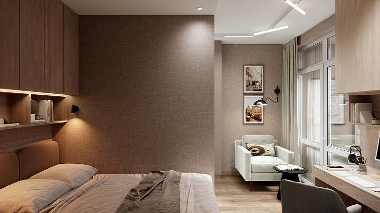 фото:Компактная спальня в нейтральных бежево-коричневых тонах. Зонирование: спальная зона с кроватью и навесным шкафом, рабочая зона с письменным столом и креслом, уголок для отдыха с креслом и кофейным столиком. Текстурированные стены, лаконичные светильники, картины в рамах добавляют уюта. Большое окно с лёгкими шторами обеспечивает естественный свет. Минимализм, функциональность, гармония